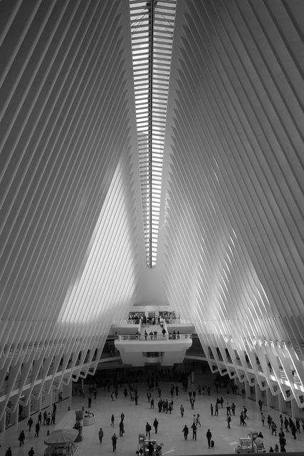 Black and white: the white ribbed hall of the Oculus with crowds on the floor below